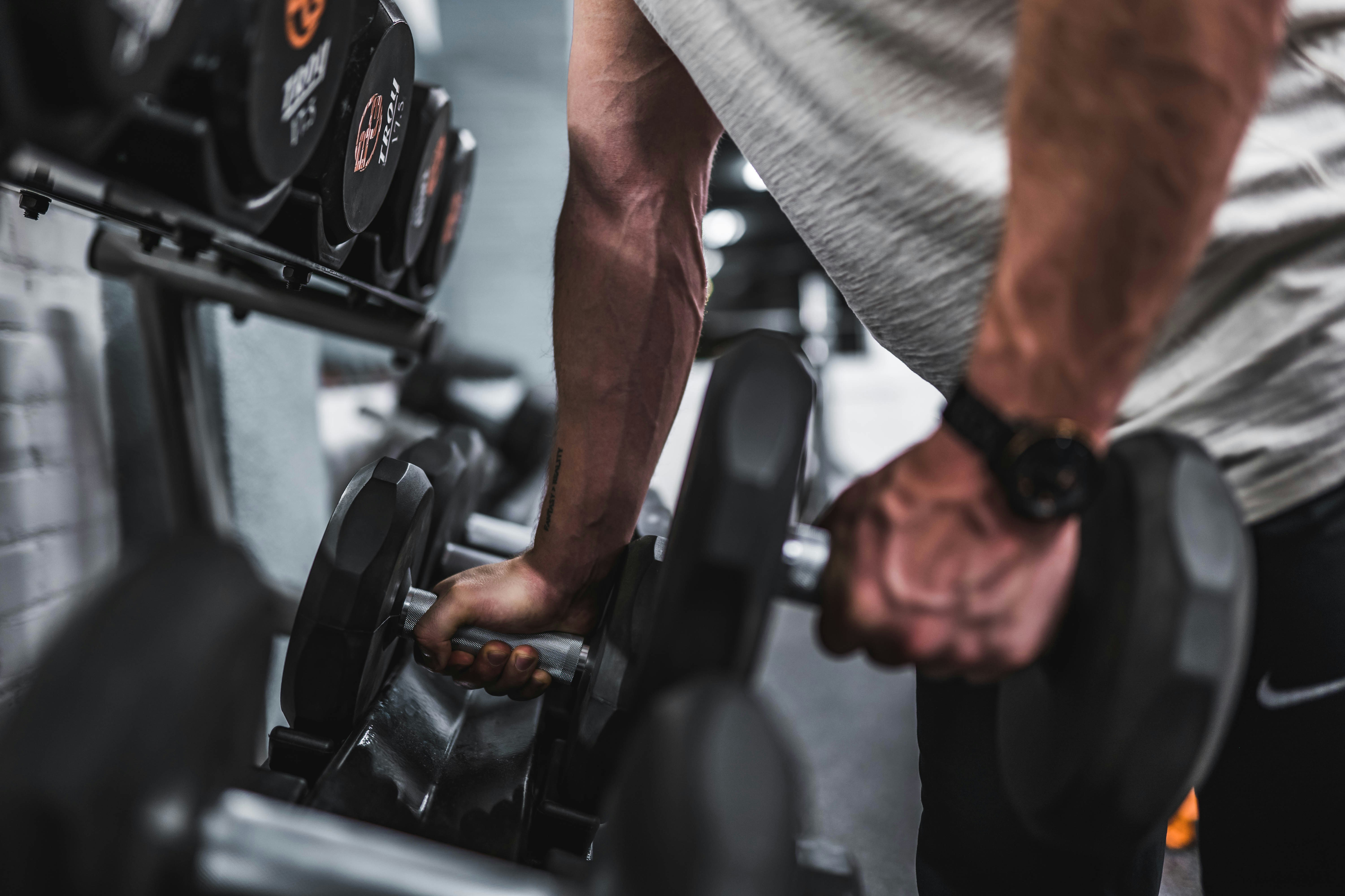 Close-up of barbell and weight plates on a gym floor
